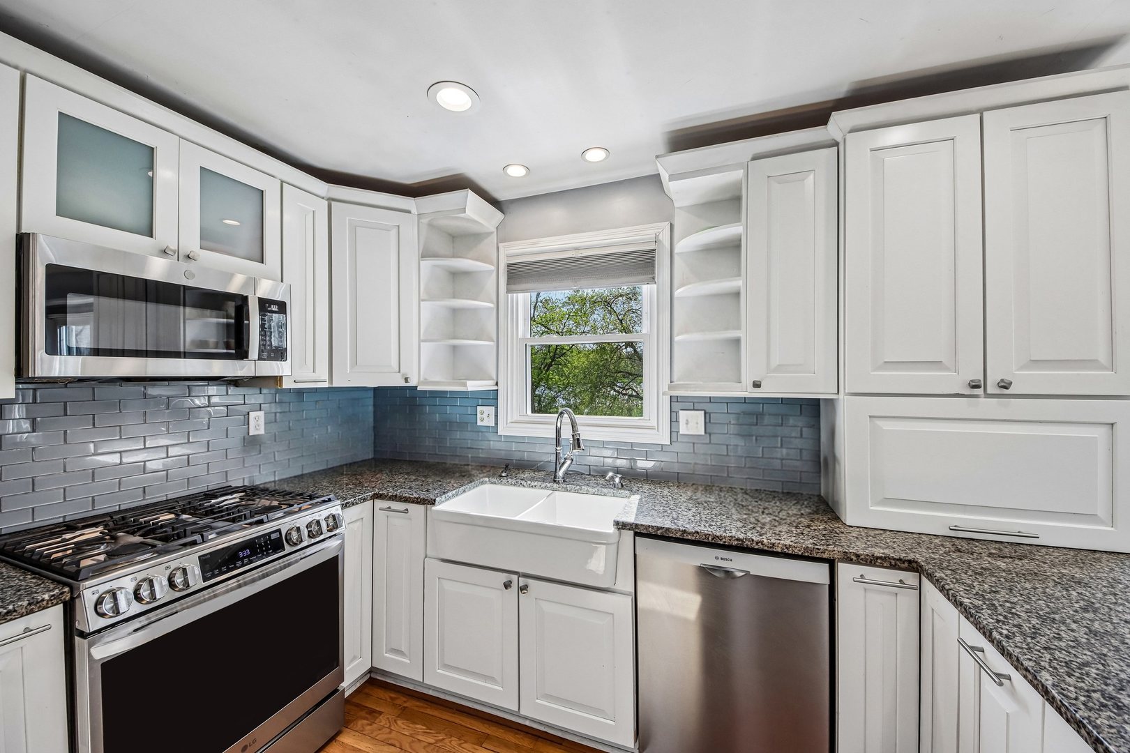 355 Council Trail Lake In The Hills, IL 60156 - Photo 4 of 35 a kitchen with granite countertop a sink stainless steel appliances and white cabinets