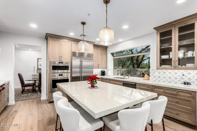 a kitchen with stainless steel appliances kitchen island granite countertop a sink and cabinets