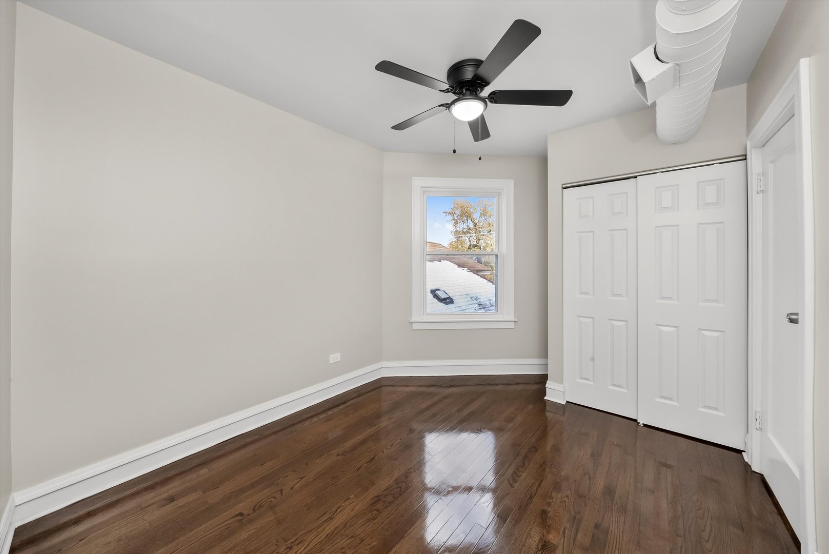8331 South Morgan Street Chicago, IL 60620 - Photo 14 of 40 an empty room with wooden floor chandelier fan and windows