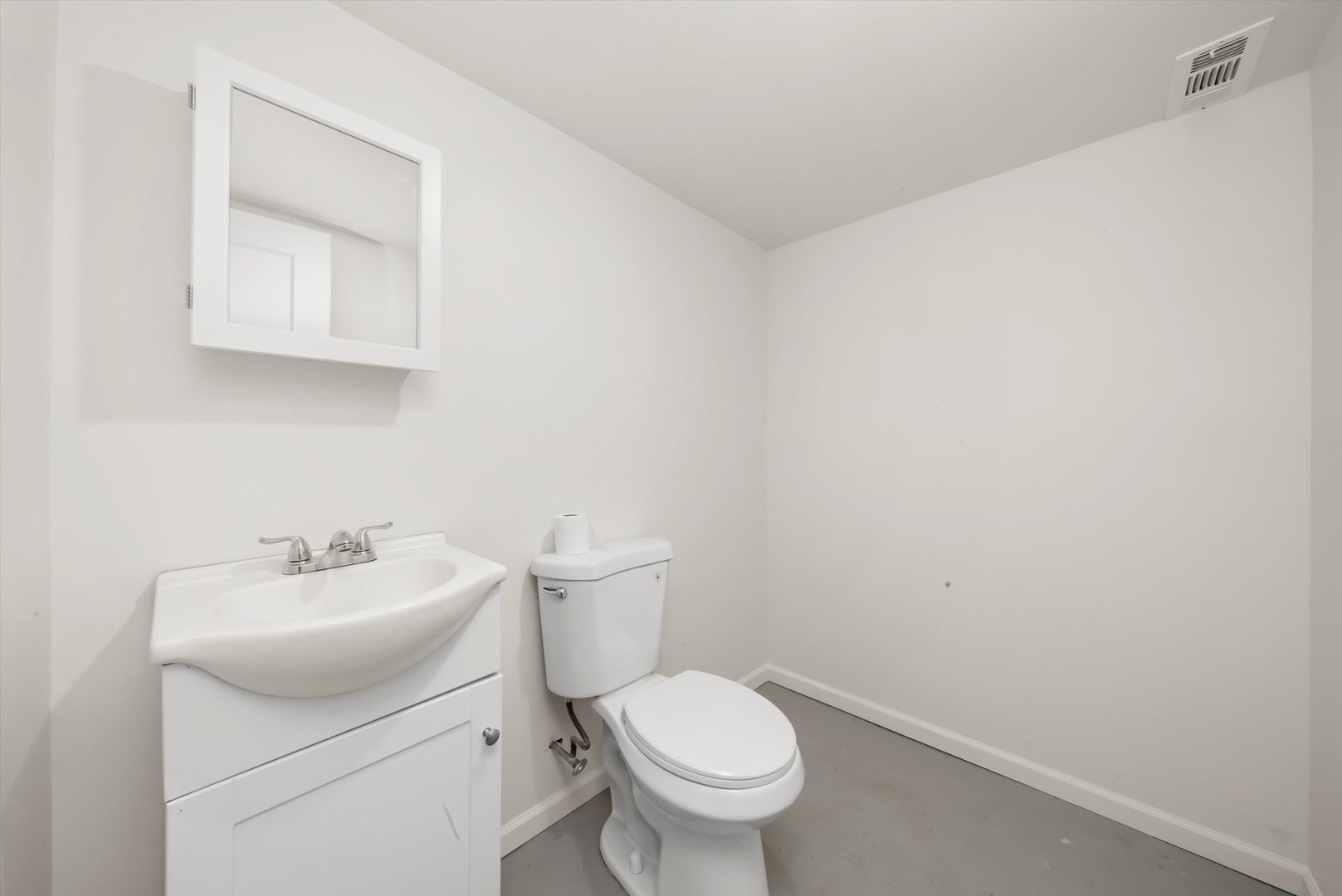 8331 South Morgan Street Chicago, IL 60620 - Photo 30 of 40 a white toilet sitting next to a bathroom sink