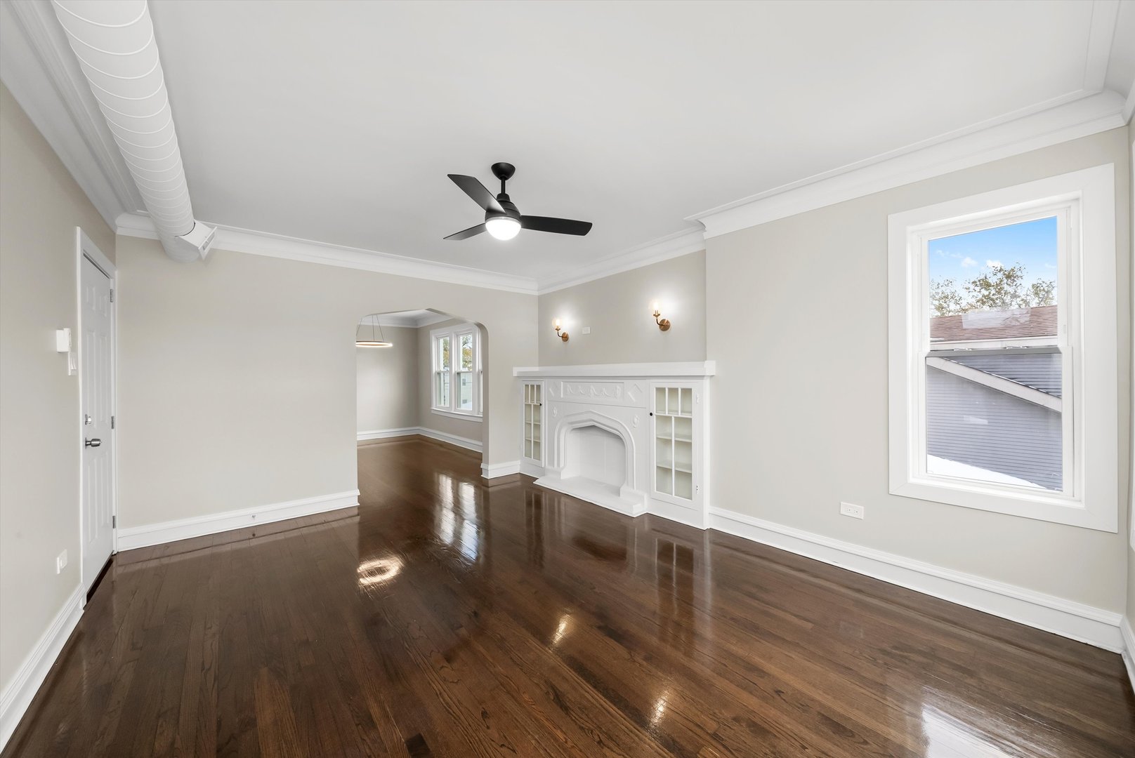 8331 South Morgan Street Chicago, IL 60620 - Photo 3 of 40 a view of empty room with wooden floor and fan