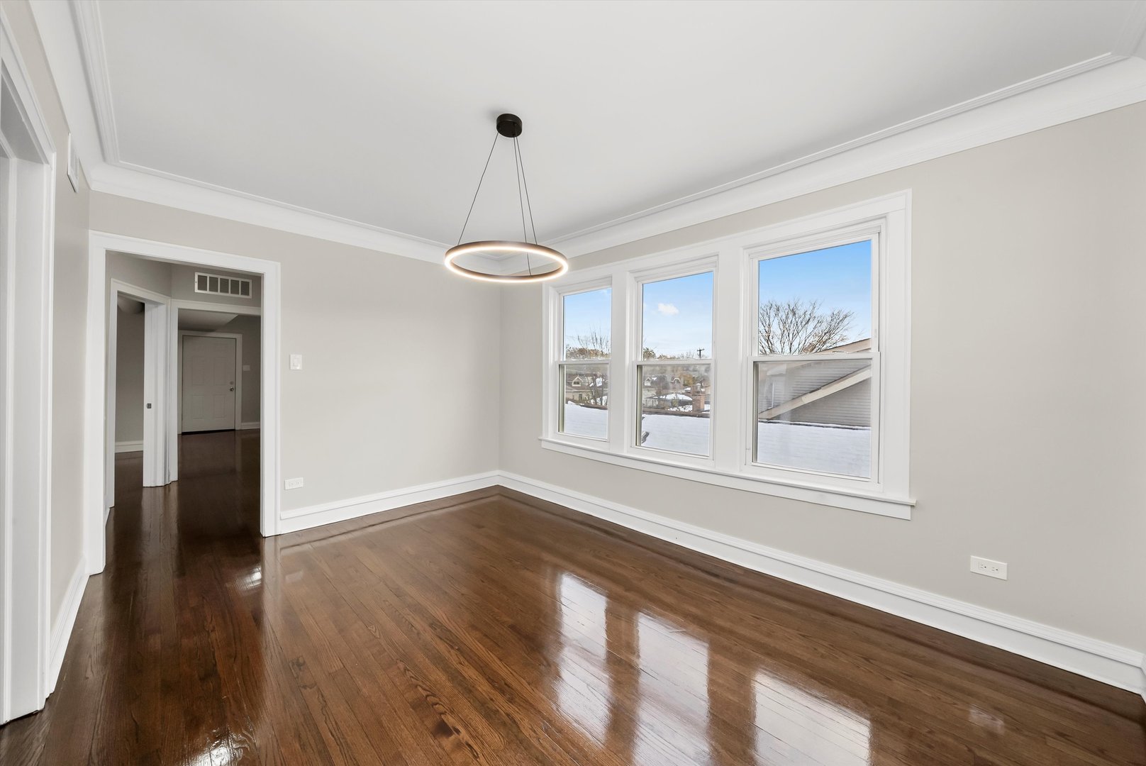 8331 South Morgan Street Chicago, IL 60620 - Photo 6 of 40 a view of an empty room with a window and wooden floor