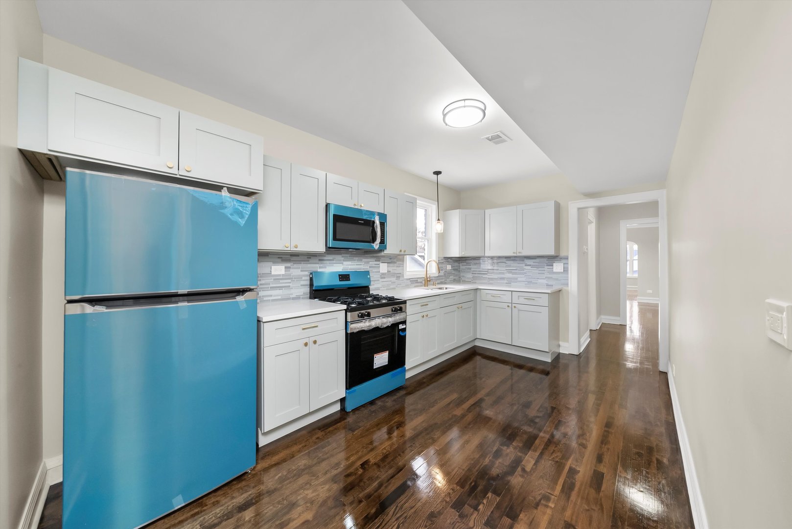 8331 South Morgan Street Chicago, IL 60620 - Photo 8 of 40 a kitchen with a refrigerator a sink cabinets and wooden floor