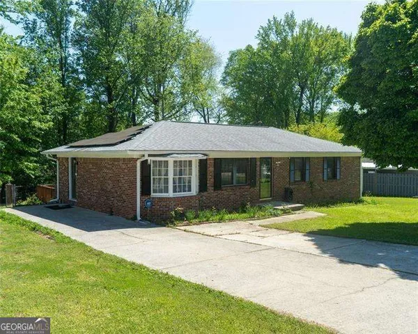 a front view of a house with a yard and porch