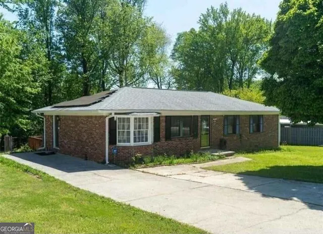 a front view of a house with a garden