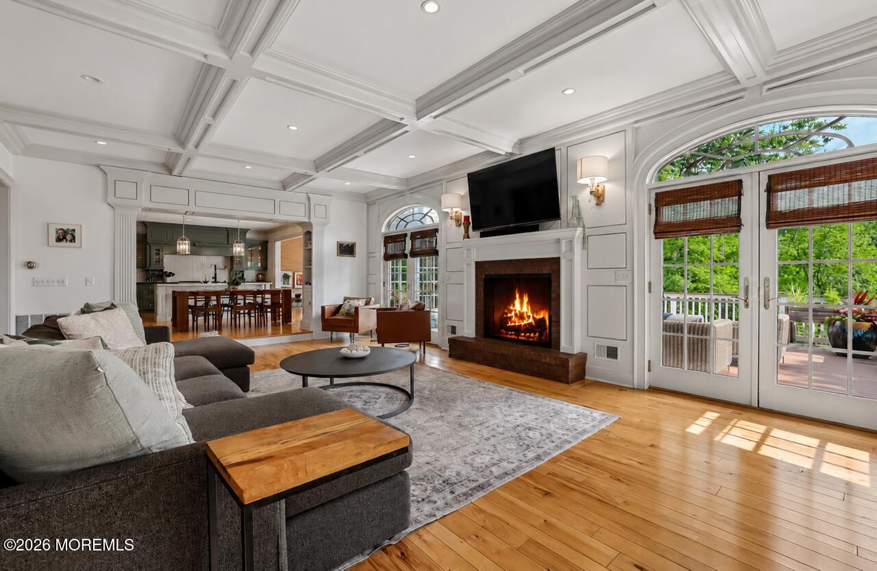 92 Tulip Lane Colts Neck, NJ 07722 - Photo 10 of 55 a living room with furniture a flat screen tv and a fireplace