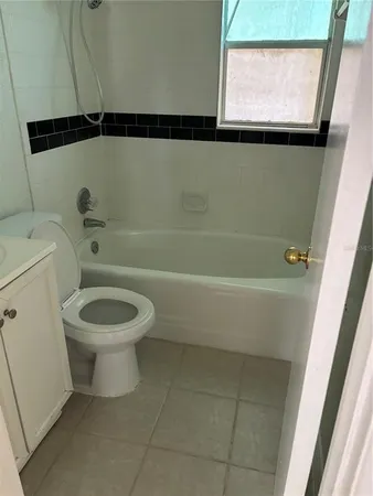 a bathroom with a toilet a sink and a mirror