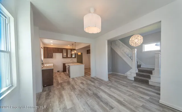 a view of a hallway to a livingroom with furniture