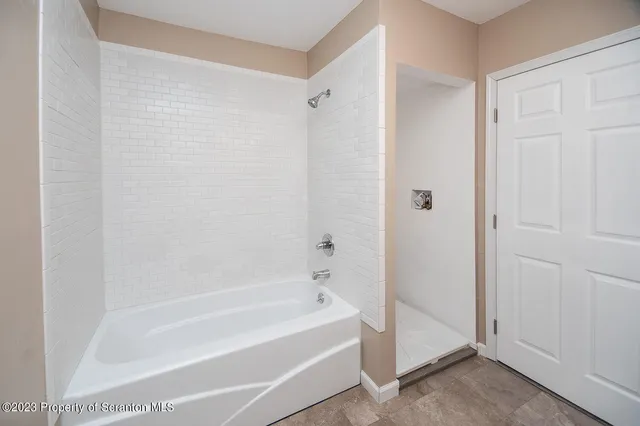 a bathroom with a bathtub and a shower