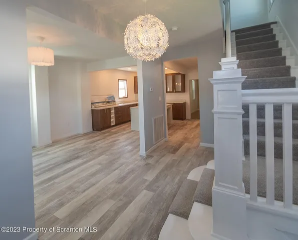 a view of a living room and kitchen with a large window