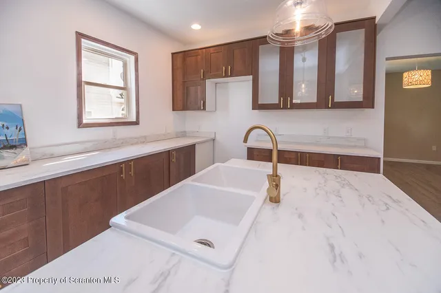 a kitchen with a sink a window and cabinets