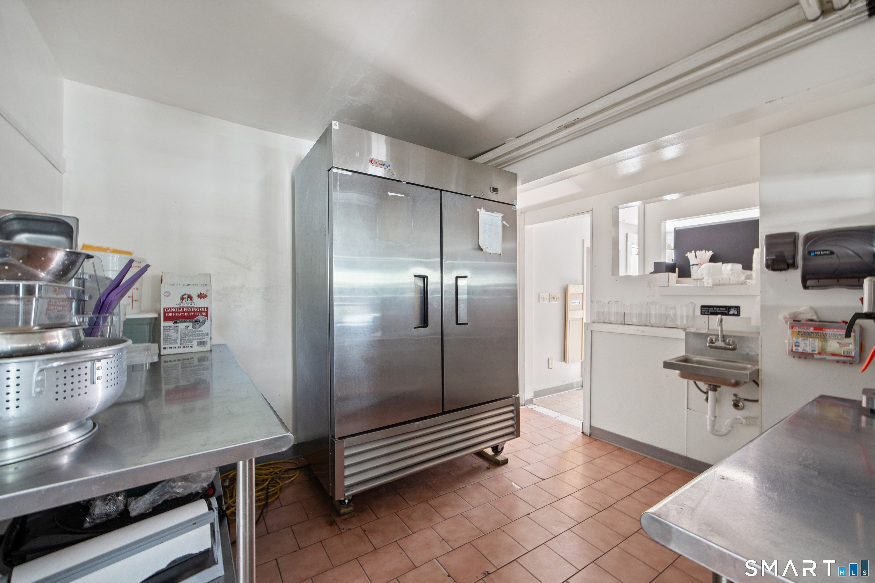 277 South Main Street Torrington, CT 06790 - Photo 8 of 26 a kitchen with kitchen island a counter top space a sink stainless steel appliances and cabinets