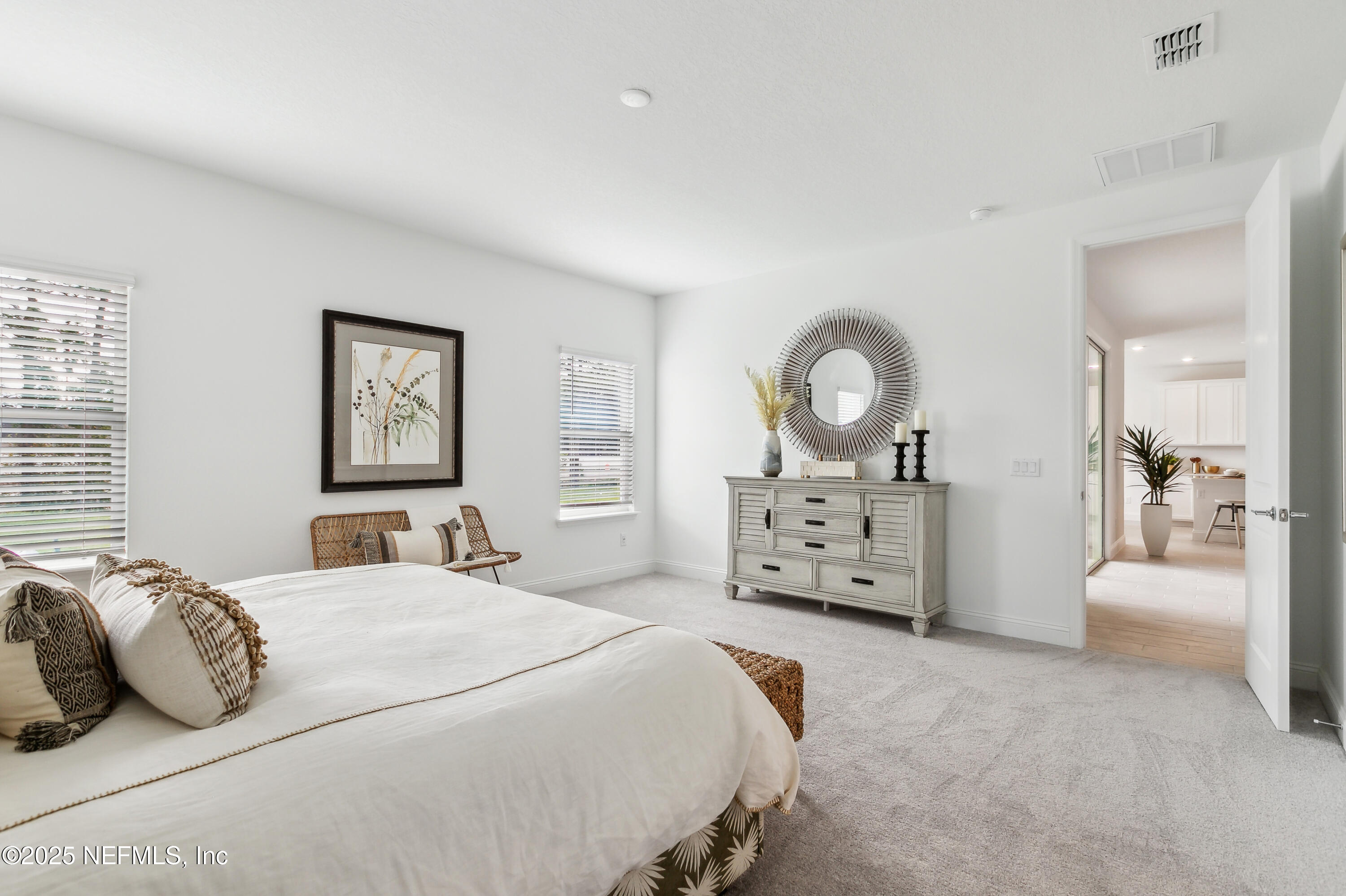 3363 Tupelo Loop Green Cove Springs, FL 32043 - Photo 12 of 26 a bedroom with bed and a large mirror