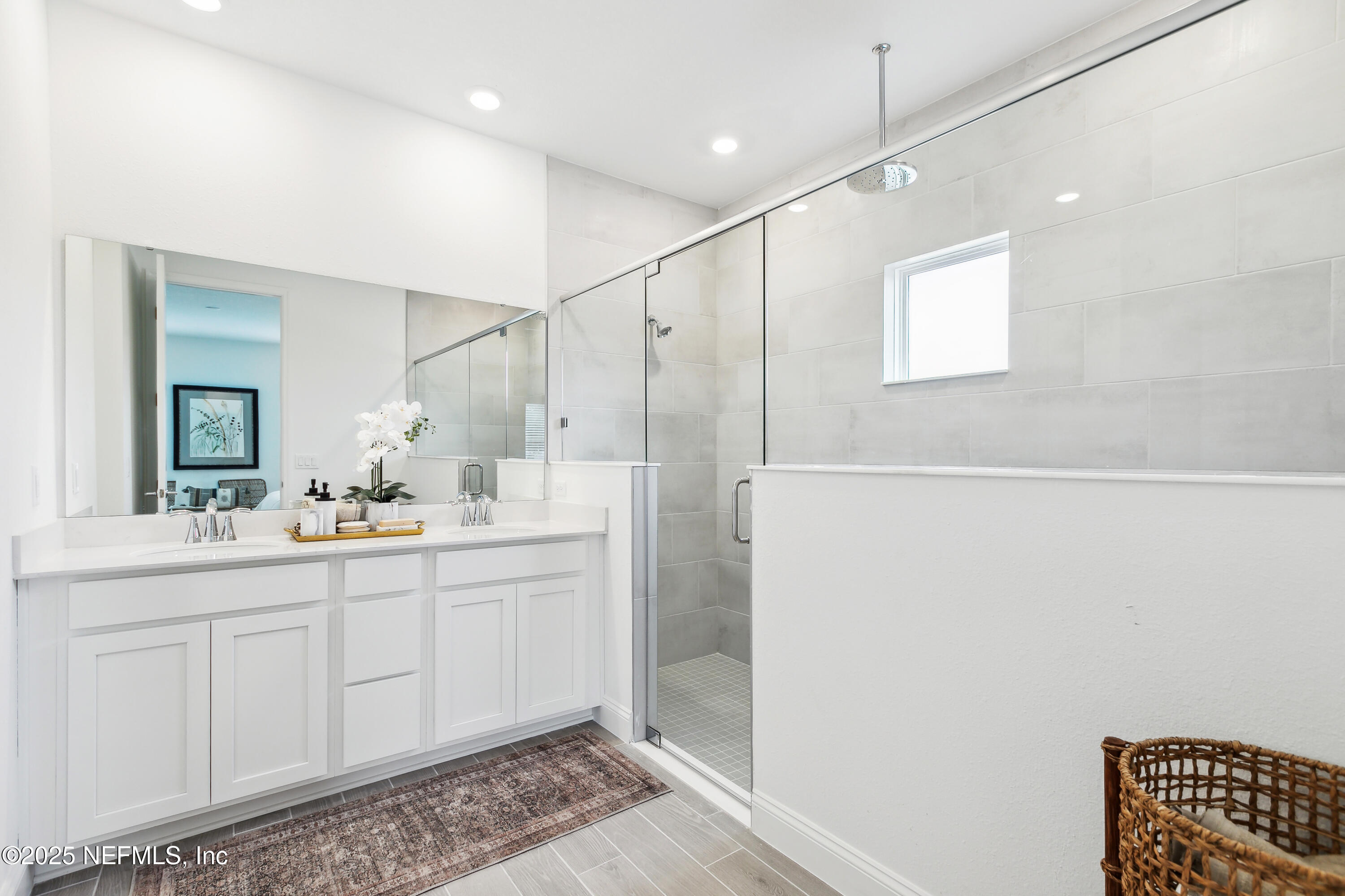 3363 Tupelo Loop Green Cove Springs, FL 32043 - Photo 13 of 26 a bathroom with a double vanity sink a mirror and a shower