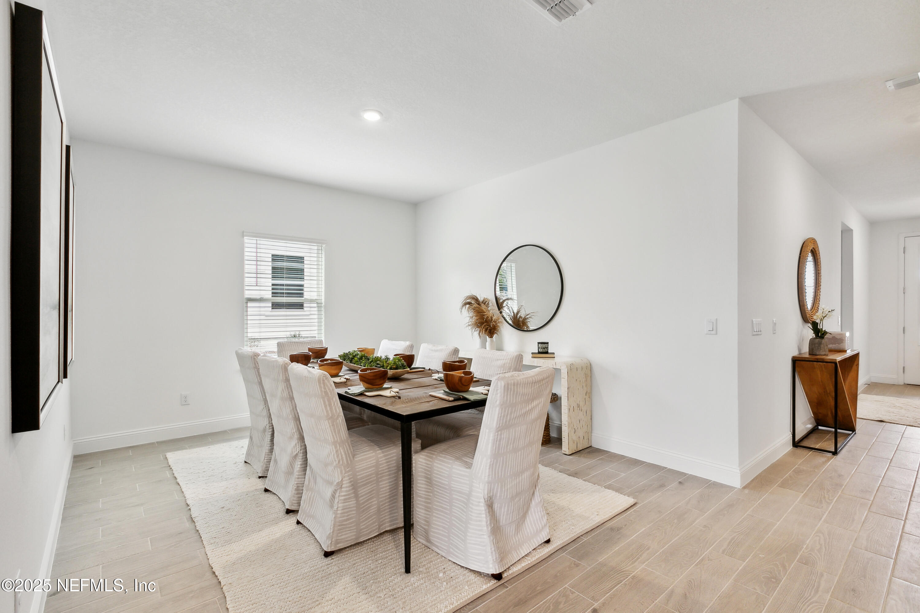 3363 Tupelo Loop Green Cove Springs, FL 32043 - Photo 19 of 26 a dining room with furniture and wooden floor