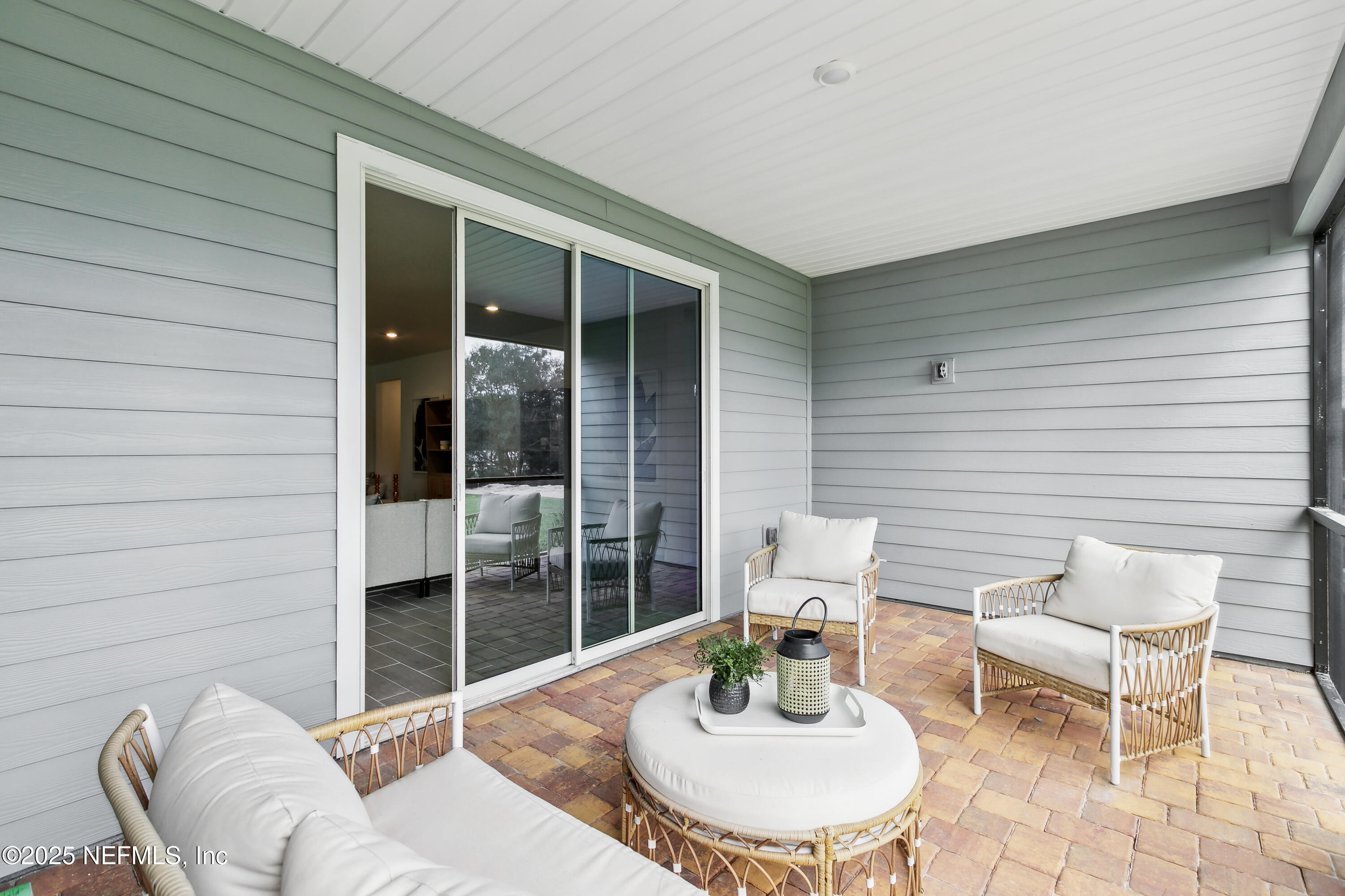 3363 Tupelo Loop Green Cove Springs, FL 32043 - Photo 22 of 26 a view of a patio with couple of chairs and potted plants
