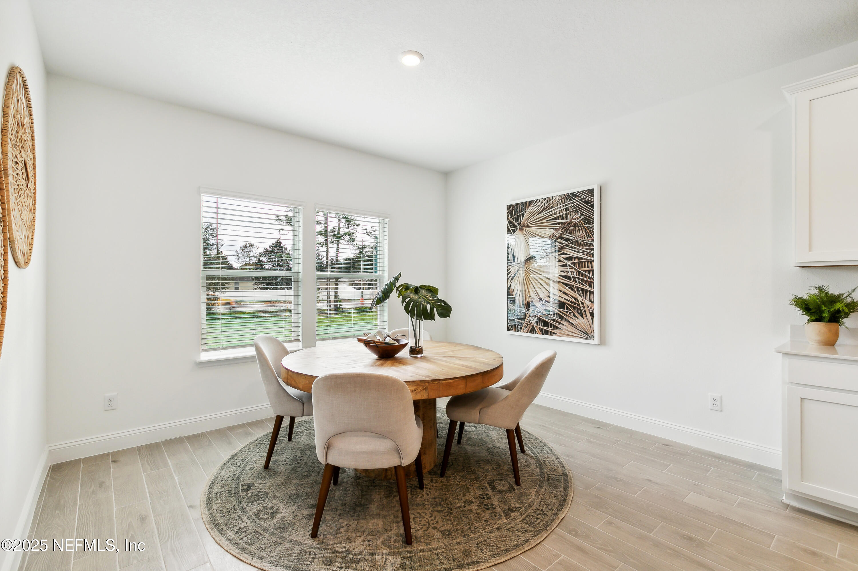 3363 Tupelo Loop Green Cove Springs, FL 32043 - Photo 8 of 26 a dining room with furniture a rug and wooden floor