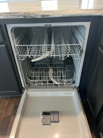 a kitchen with stainless steel appliances granite countertop a sink a stove and a wooden floor