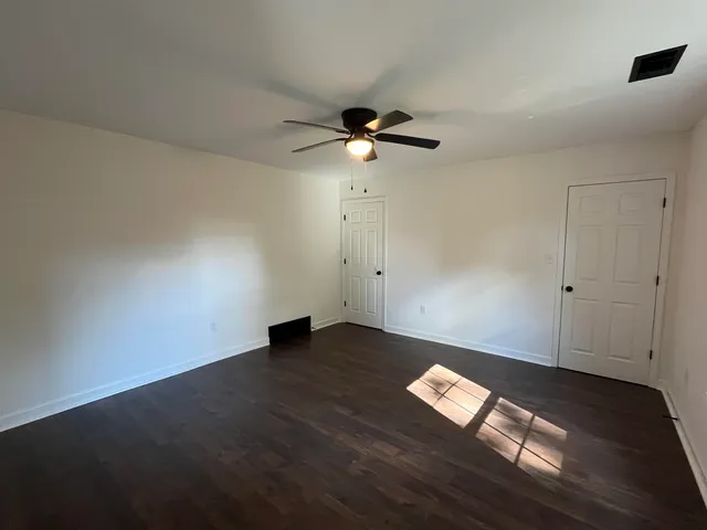 a view of a room with wooden floor