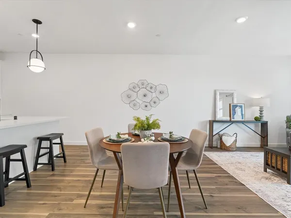 a kitchen with stainless steel appliances a stove a sink island and white cabinets