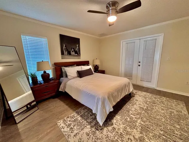 a bedroom with a bed and a large window