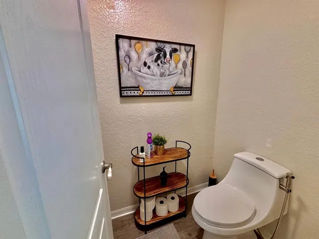 a bathroom with a toilet a sink and vanity