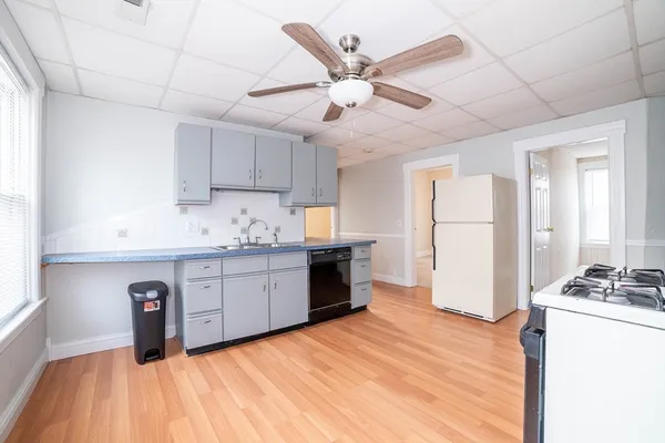 a kitchen with granite countertop a sink stainless steel appliances and cabinets