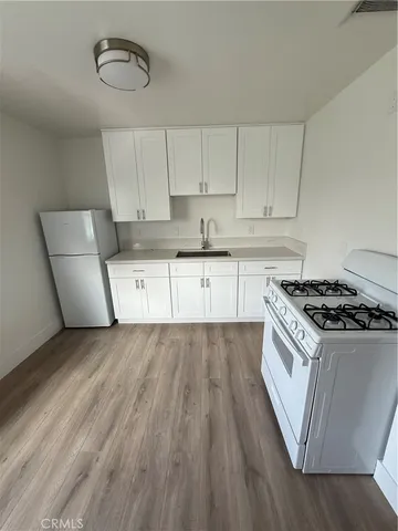 a kitchen with stainless steel appliances granite countertop a stove a sink and a refrigerator