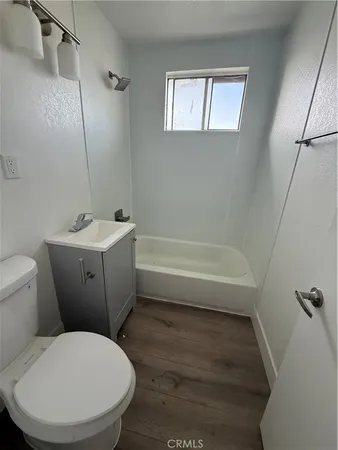 a bathroom with a toilet a sink and bathtub