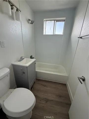 a bathroom with a toilet a sink and bathtub