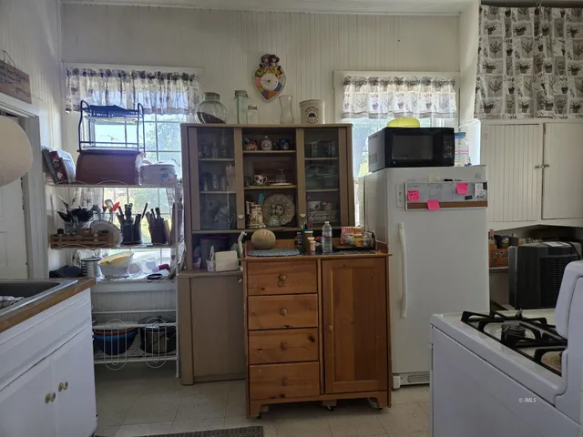 a room with wooden floor and furniture