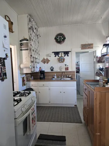 a kitchen with a cabinets and wooden floor