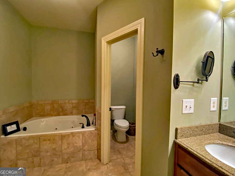 1045 Paynes Creek Road Hartwell, GA 30643 - Photo 15 of 37 a bathroom with a granite countertop sink and a mirror
