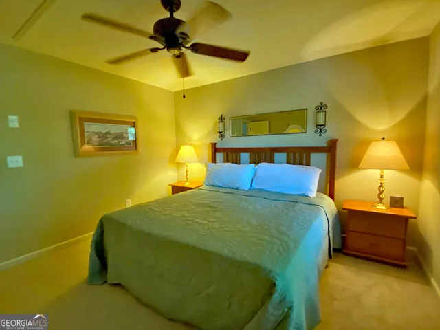 a bedroom with a bed and a painting on the wall