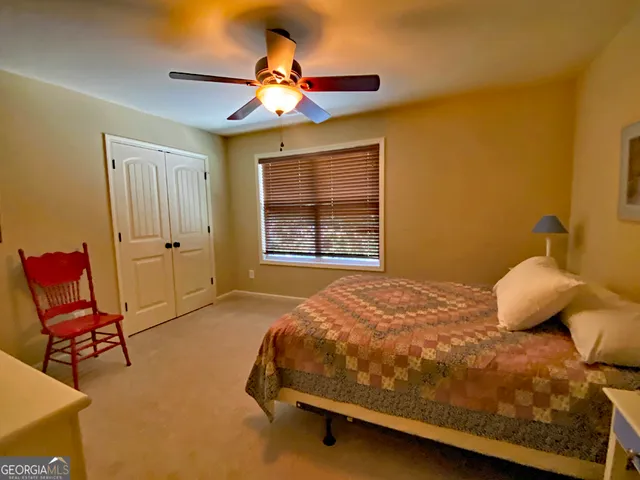 a bedroom with a bed and chair