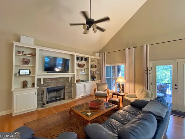 a living room with furniture a flat screen tv and a fireplace