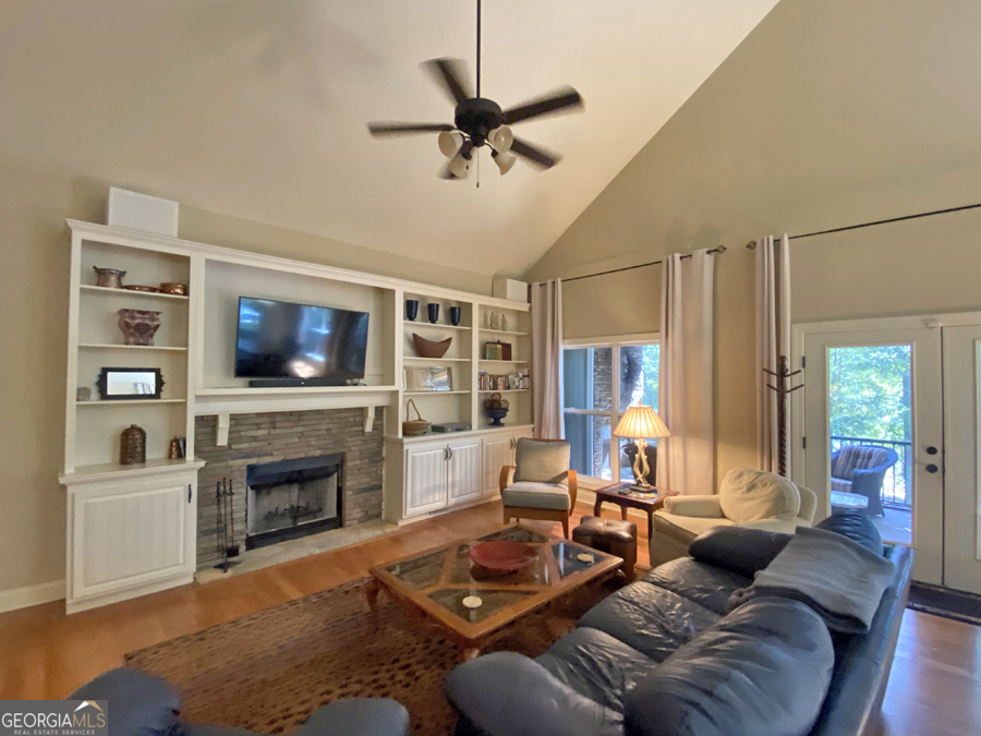 1045 Paynes Creek Road Hartwell, GA 30643 - Photo 2 of 37 a living room with furniture a flat screen tv and a fireplace