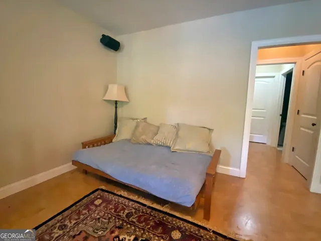 a bedroom with a bed and a rug