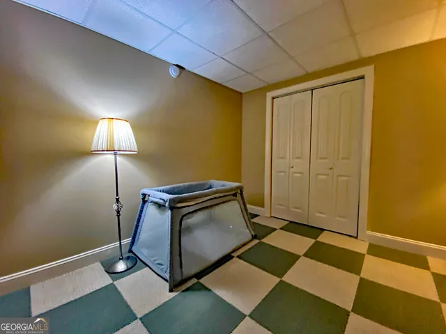 a room with a lamp and a rug