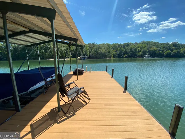 a view of a balcony with chairs and a potted plant