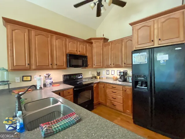 a kitchen with stainless steel appliances granite countertop a refrigerator stove and sink