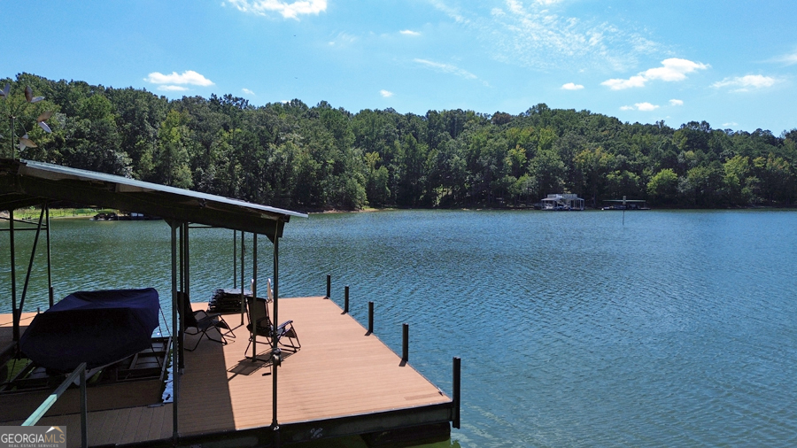 1045 Paynes Creek Road Hartwell, GA 30643 - Photo 31 of 37 a view of a balcony with chairs and a potted plant