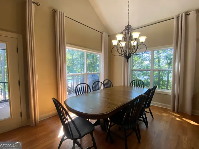 a view of a dining room with furniture wooden floor and chandelier