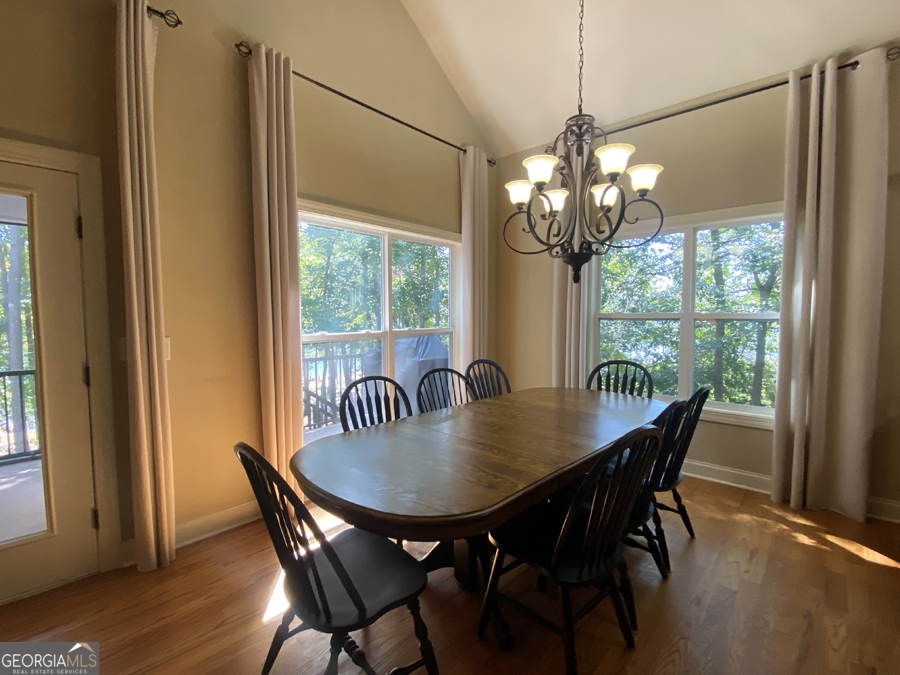 1045 Paynes Creek Road Hartwell, GA 30643 - Photo 4 of 37 a view of a dining room with furniture wooden floor and chandelier