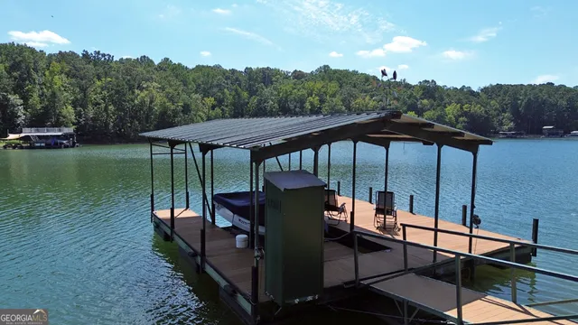 a view of a patio with chairs under an umbrella