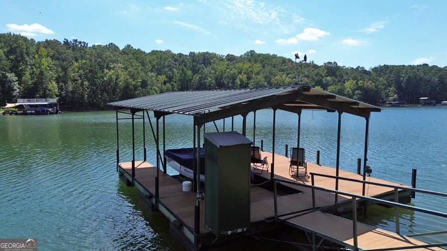 1045 Paynes Creek Road Hartwell, GA 30643 - Photo 9 of 37 a view of a patio with chairs under an umbrella