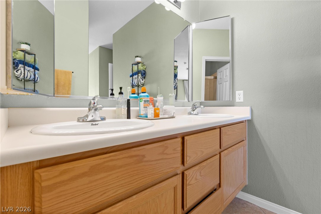 3238 Mystic Ridge Court Las Vegas, NV 89129 - Photo 11 of 31 Double vanities with ample counter space create a functional and pleasant bathroom.