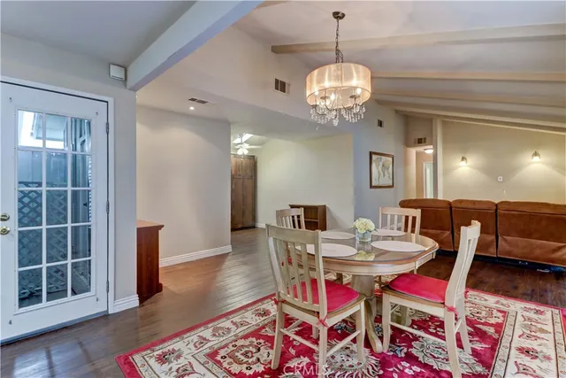 a kitchen with granite countertop a refrigerator stove top oven and sink