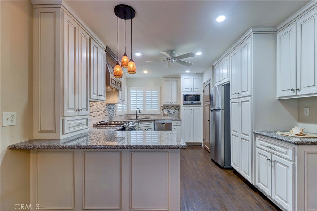 2509 View Lake Santa Ana, CA 92705 - Photo 21 of 74 a kitchen with refrigerator a sink and cabinets