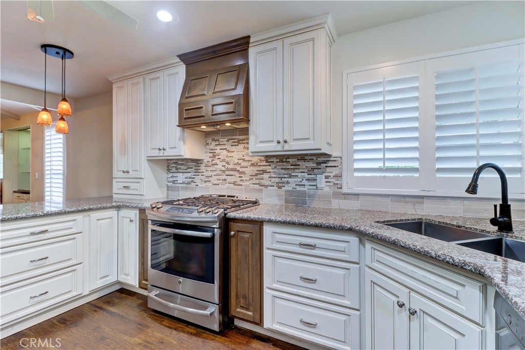 2509 View Lake Santa Ana, CA 92705 - Photo 24 of 74 a kitchen with granite countertop white cabinets and white appliances